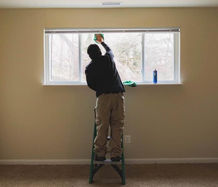 Man cleaning window